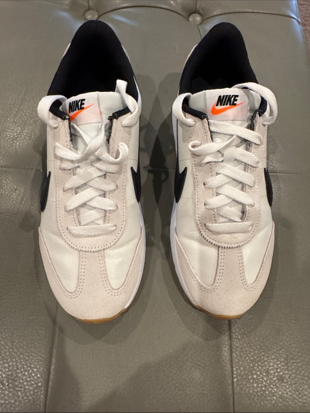 Nike Men’s White Sneakers with Black Swoosh and Orange Accent